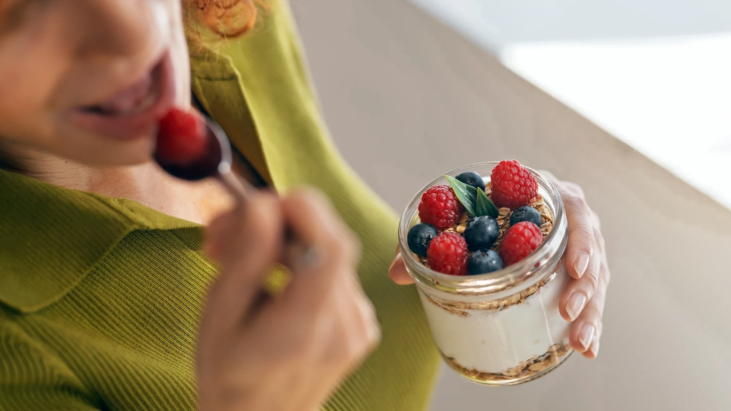 Close-up berries with yogurt and granola.