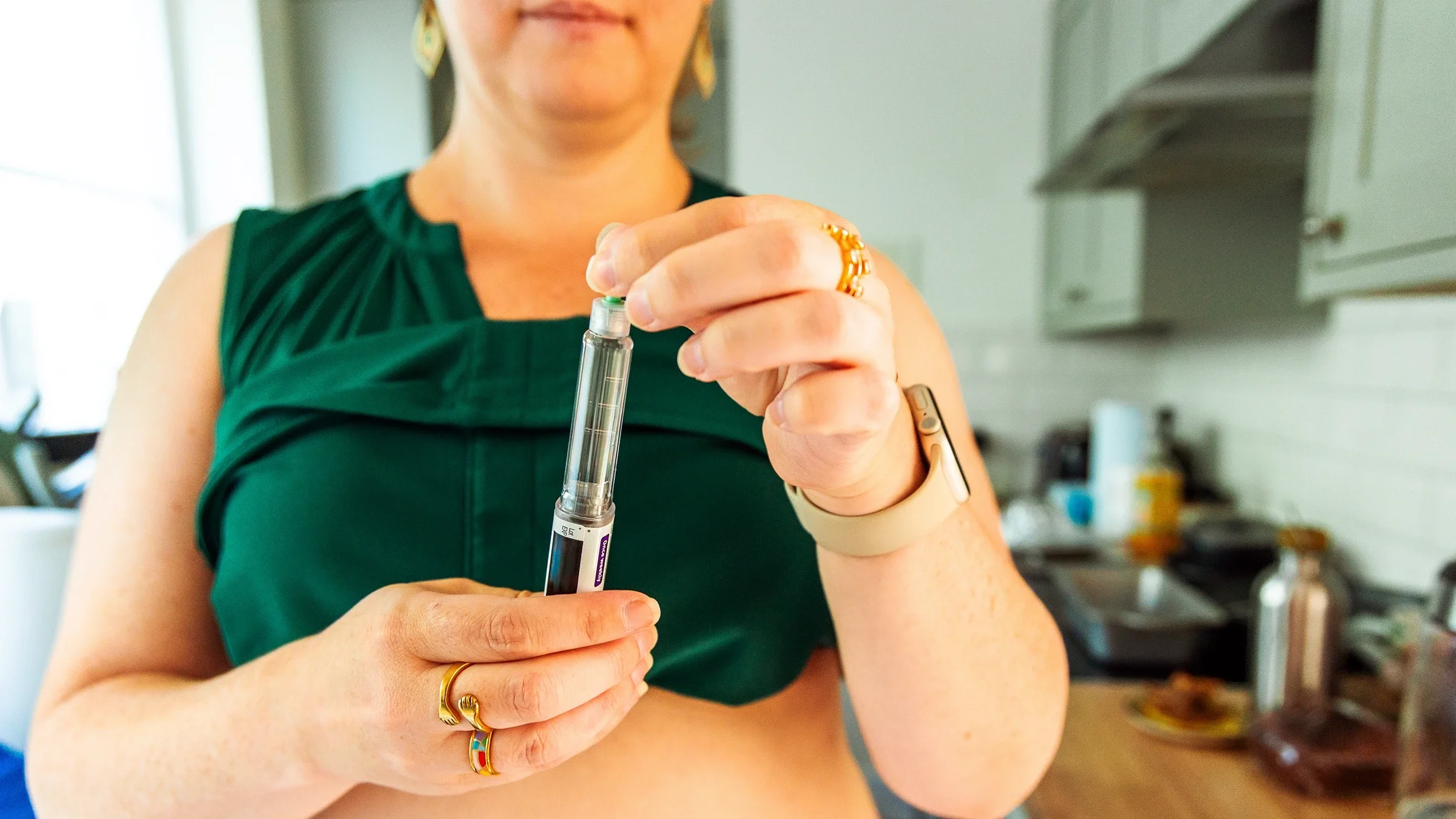 Close-up of a woman's hands holding a weight loss injection pen