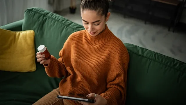 melatonin: woman researches medication on internet 1958382063