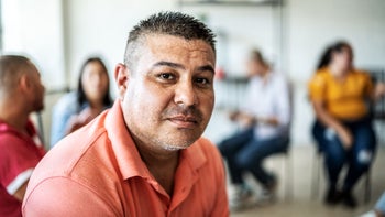 mental health: mens health: portrait of man during group therapy 1438224442