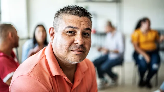 mental health: mens health: portrait of man during group therapy 1438224442