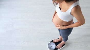 Health: Pregnancy: pregnant woman on scale-1165321727