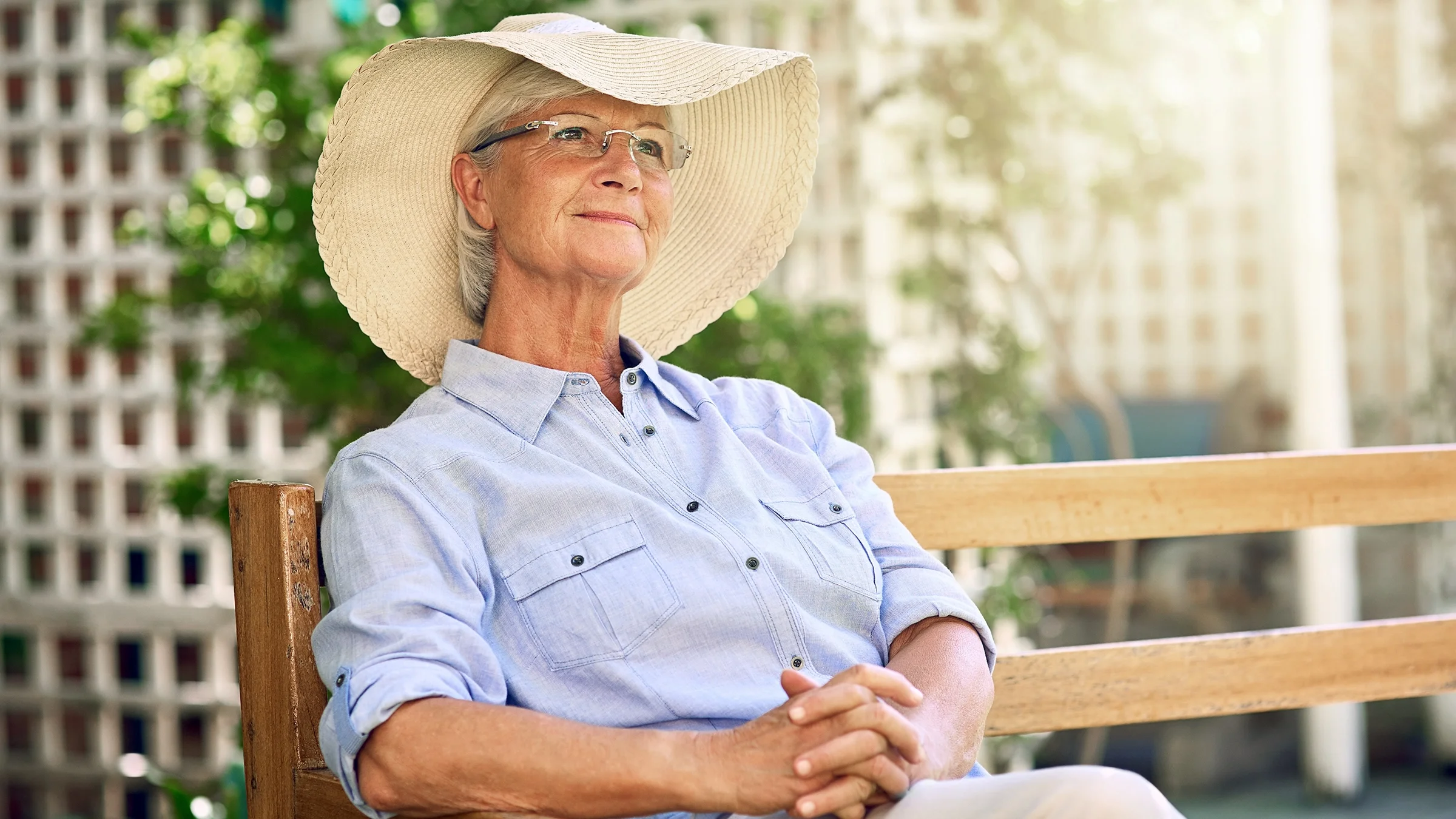 Senior woman relaxing wearing a sun hat in the garden