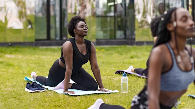 Movement exercise: woman pigeon pose outdoors 1430097291