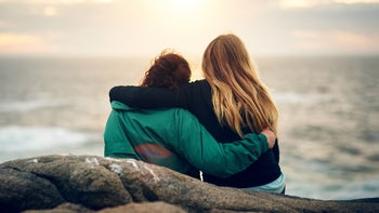 Behavioral addiction: Gambling: backs of friends with arms around each other in nature 820525782