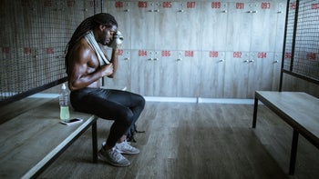 Movement Exercise: man wiping sweat in locker room 1127487117