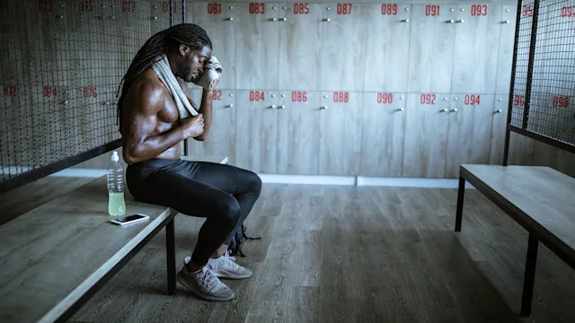Movement Exercise: man wiping sweat in locker room 1127487117