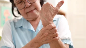 osteoporosis: woman with wrist pain 1688159320