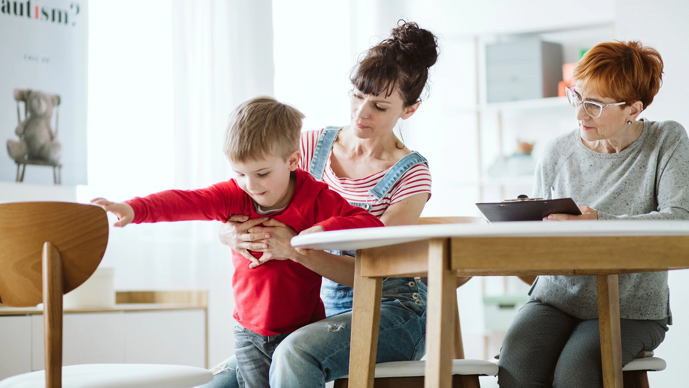 A child is having a therapy session with his mother.