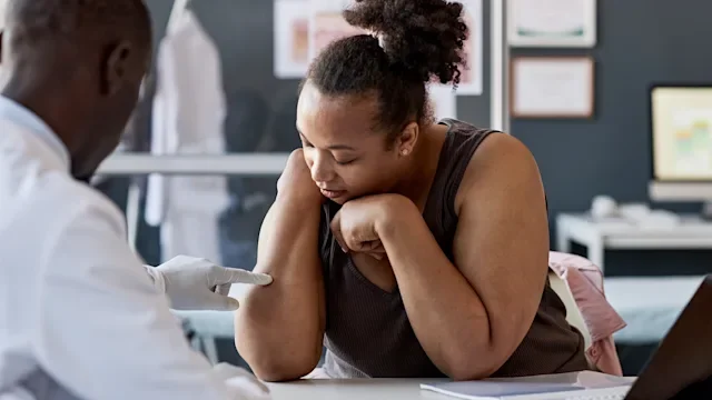 eczema: woman at derm appointment 2186297851