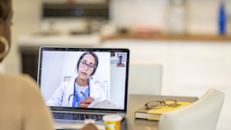 A woman is speaking to a doctor during a telehealth appointment.
FatCamera/E+ via Getty Images 