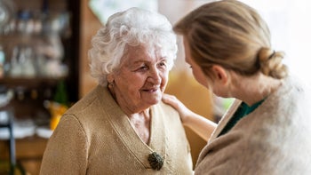 Health: Patient advocacy: nurse consoling with elderly woman-1307432596