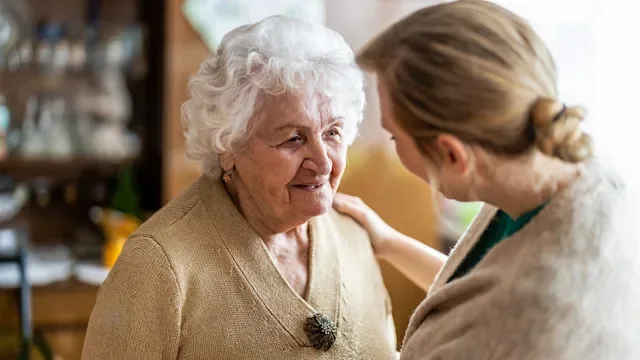 Health: Patient advocacy: nurse consoling with elderly woman-1307432596