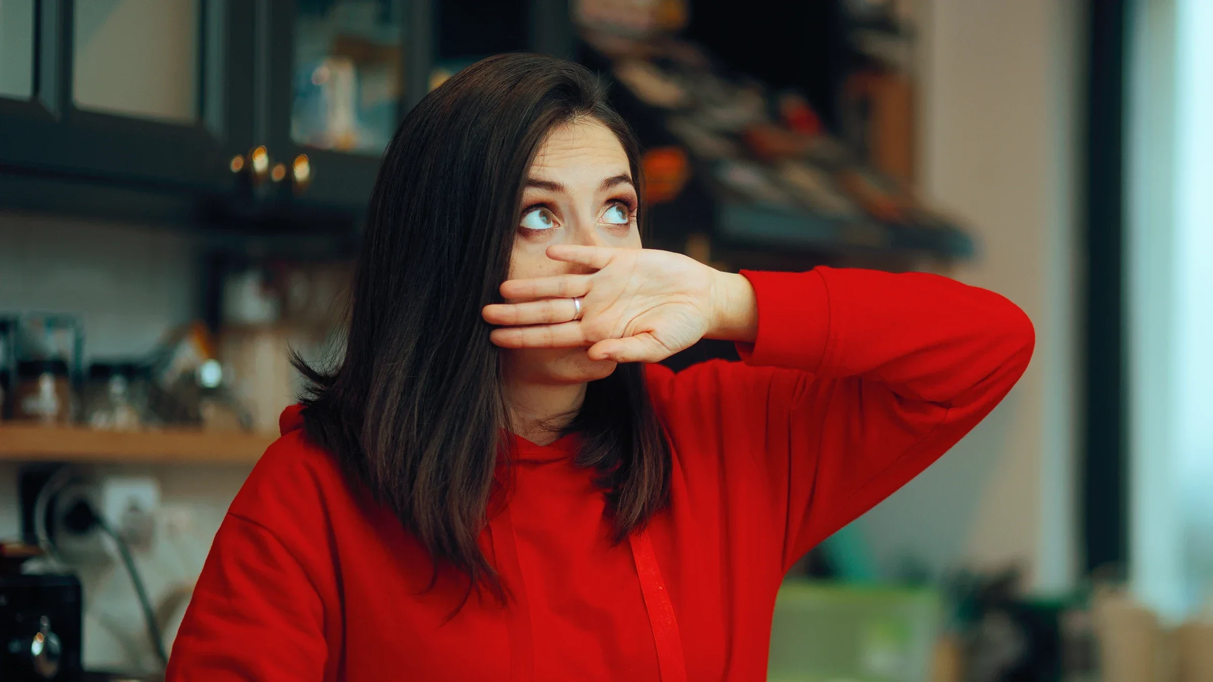 Woman covering her mouth.
nicoletaionescu/iStock via Getty Images Plus