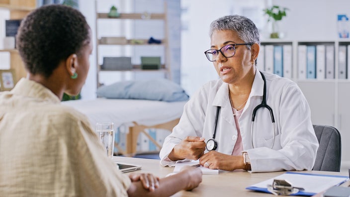 A woman is at a medical consultation.