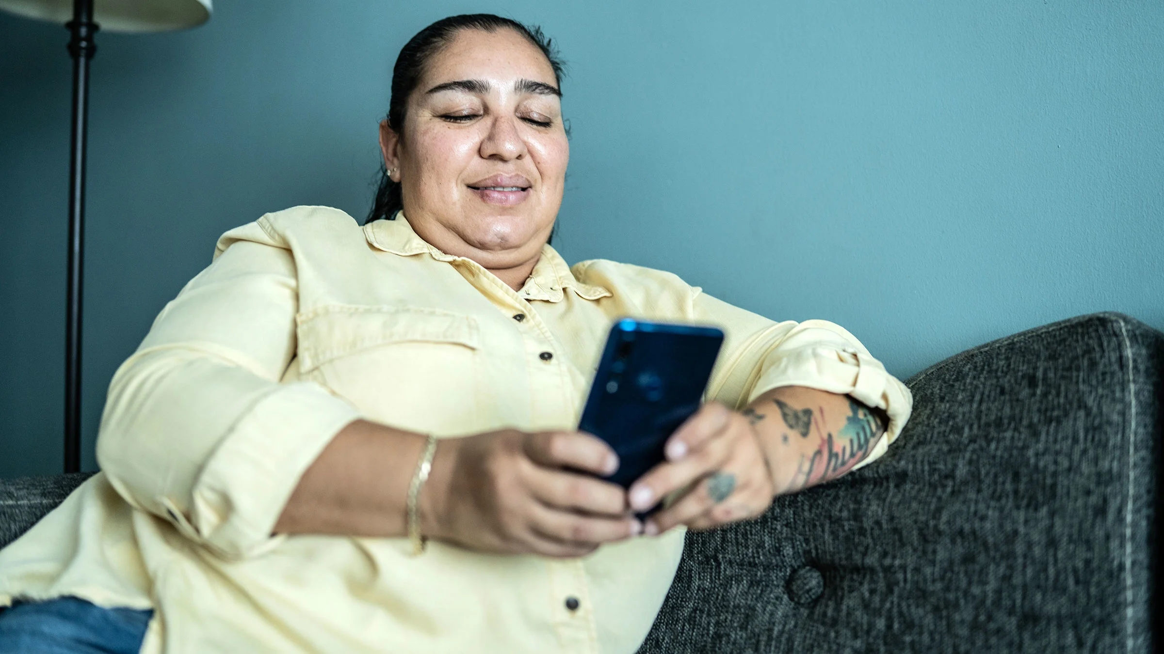 Woman uses her phone in her living room.