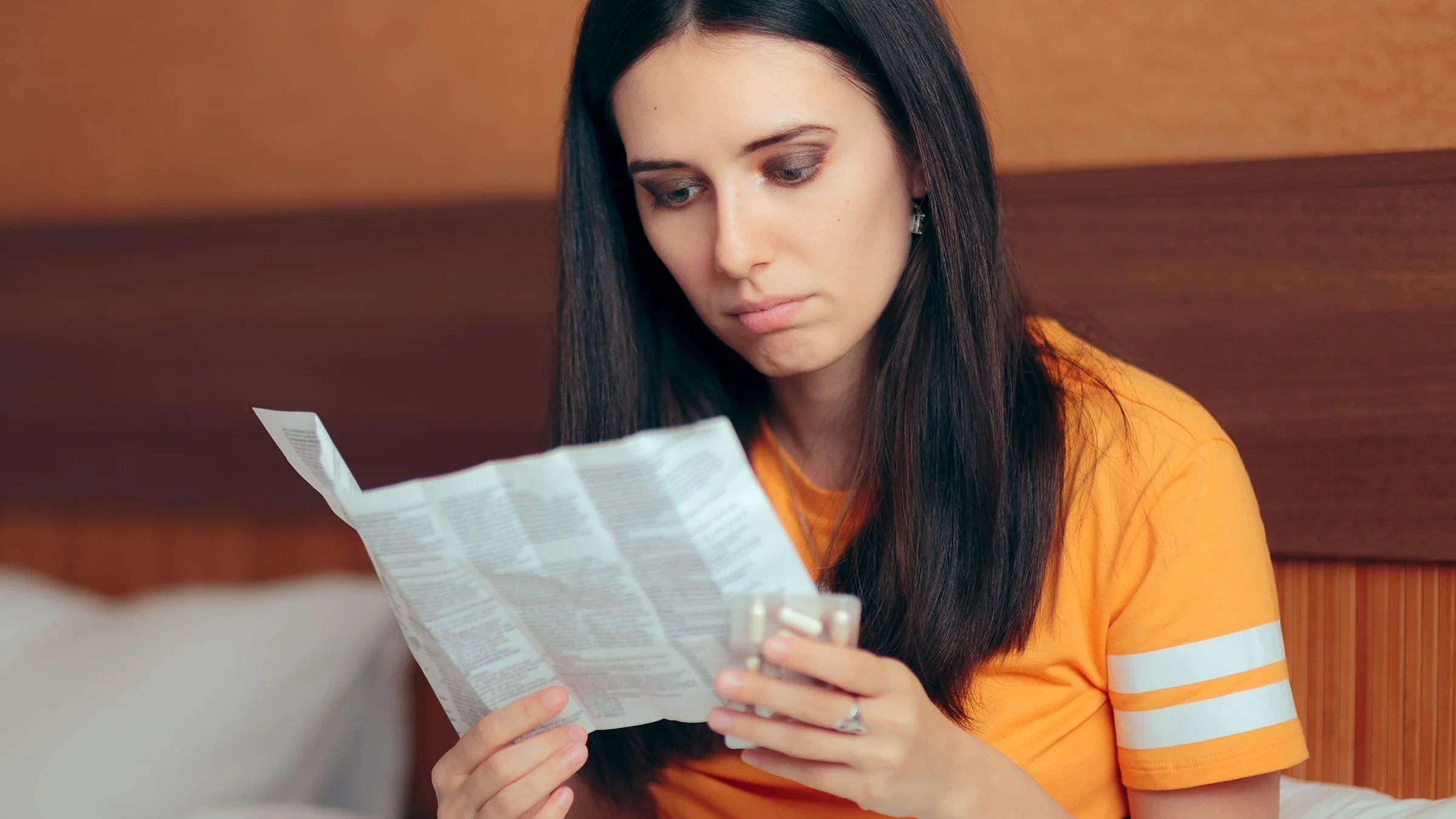 woman reading medication insert 1081247178