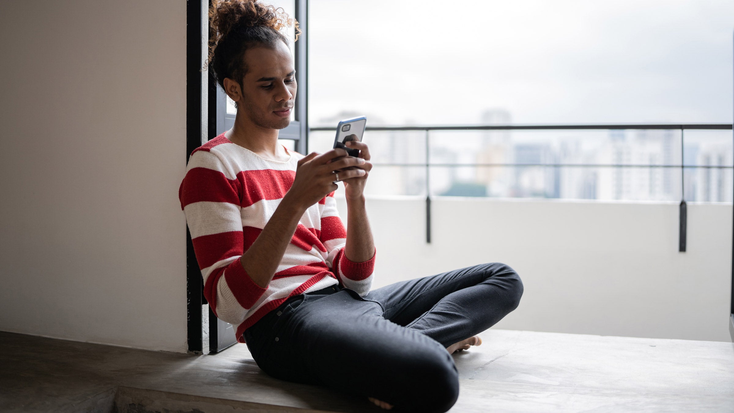 Eating disorders: using phone by window sill 1353661571