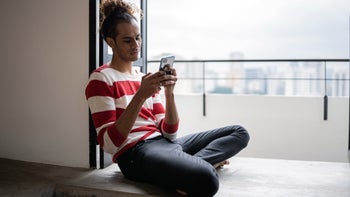 Eating disorders: using phone by window sill 1353661571