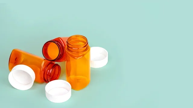 Health: empty pill bottles light green background 1360208244