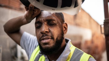Environmental-health: construction worker wiping sweat 1334826308