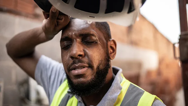 Environmental-health: construction worker wiping sweat 1334826308