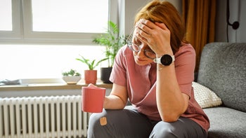 Nausea: woman drinking tea for nausea 2182650553