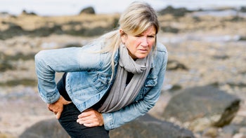 musculoskeletal-conditions: woman with hip pain outdoors-1323354958