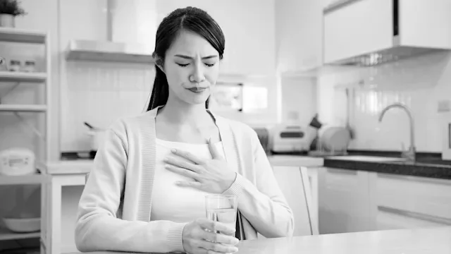 omeprazole: black and white woman with heartburn 1370424220