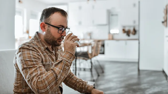 Hemorrhoids: man drinking from a glass 1993611951