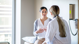 Woman at doctor's appointment discussing treatment.
FatCamera/E+ via Getty Images