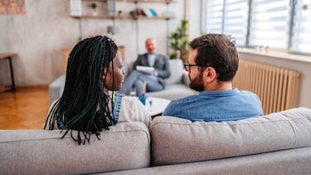 Addiction: Sex: couple sitting on couch in counseling 1399400905