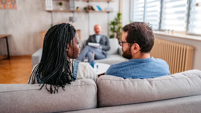 Addiction: Sex: couple sitting on couch in counseling 1399400905
