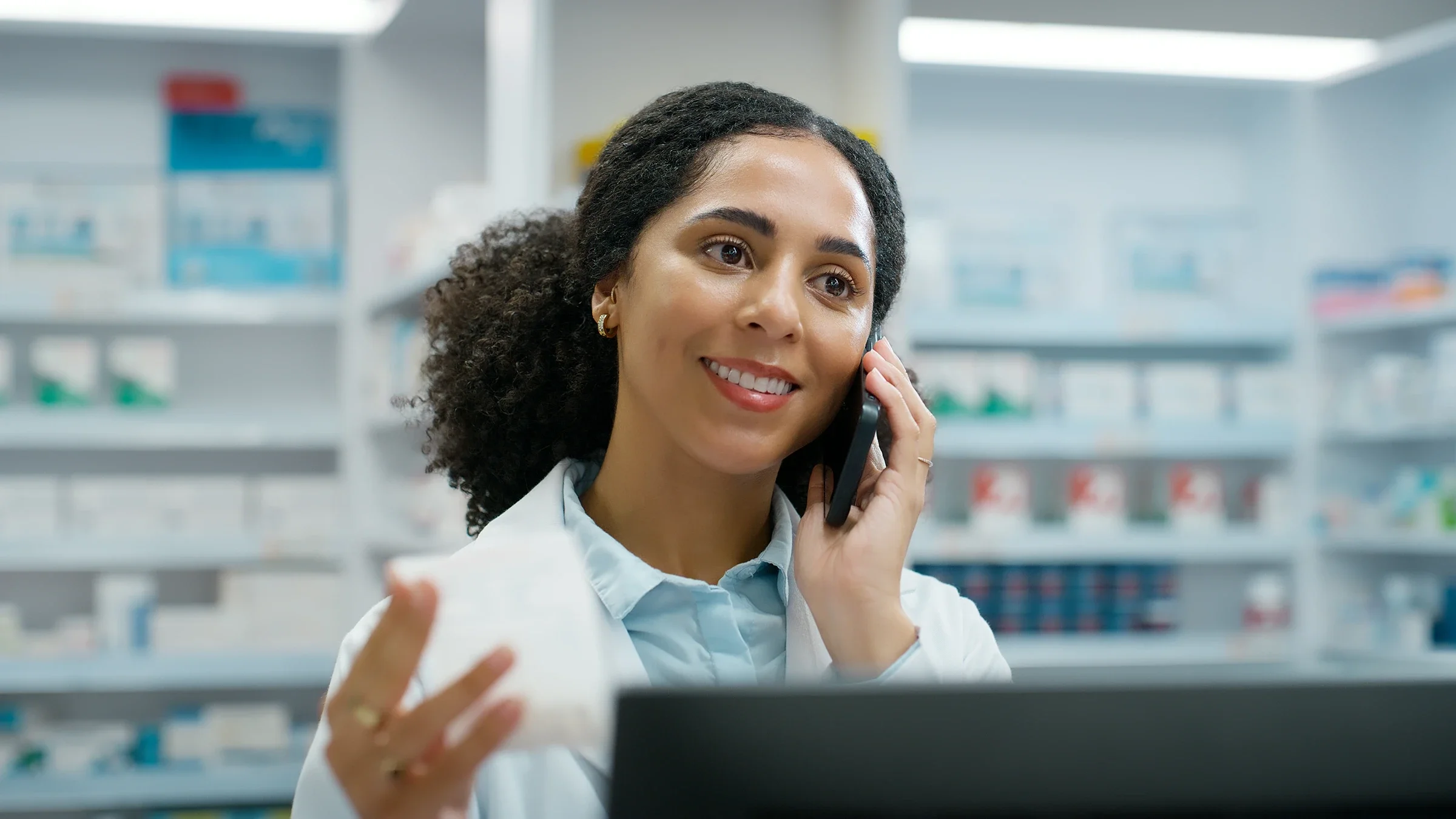A pharmacist speaks on the phone.
