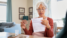 Senior woman reading drug information while holding a blister pack of medication
Ridofranz/iStock via Getty Images