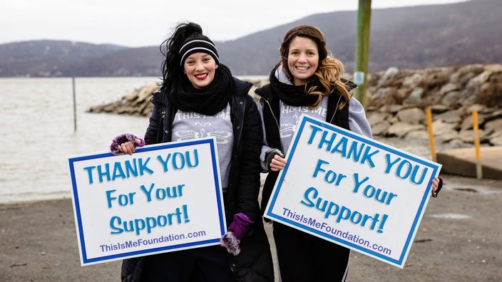 Caitlyn and Lauren Brady with support signs for their website, thisismefoundation.com, for people with alopecia.