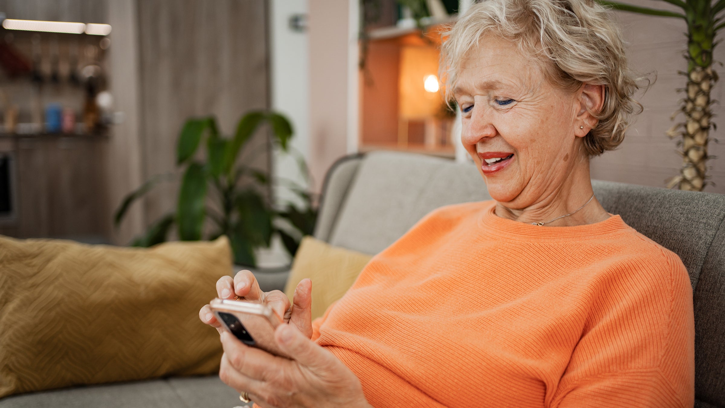 Savings: senior woman using smartphone 2185765911