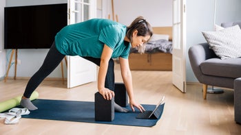 Menopause: woman doing yoga at home 1446695248