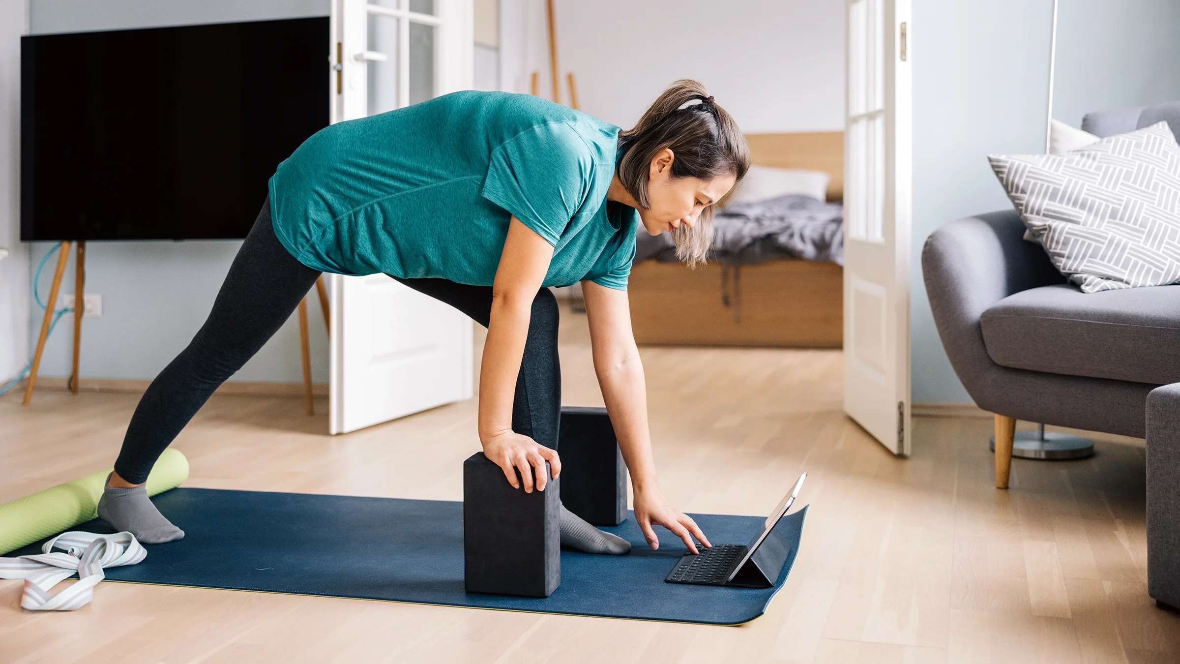 A woman practices yoga at home.
