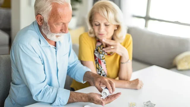 Hydrochlorothiazide: senior couple taking medication-1276611234