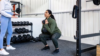 Movement exercise: woman doing weighted squat 1443831230