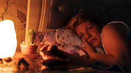 A woman lies in bed, restless and unable to sleep.
Enes Evren/iStock via Getty Images Plus