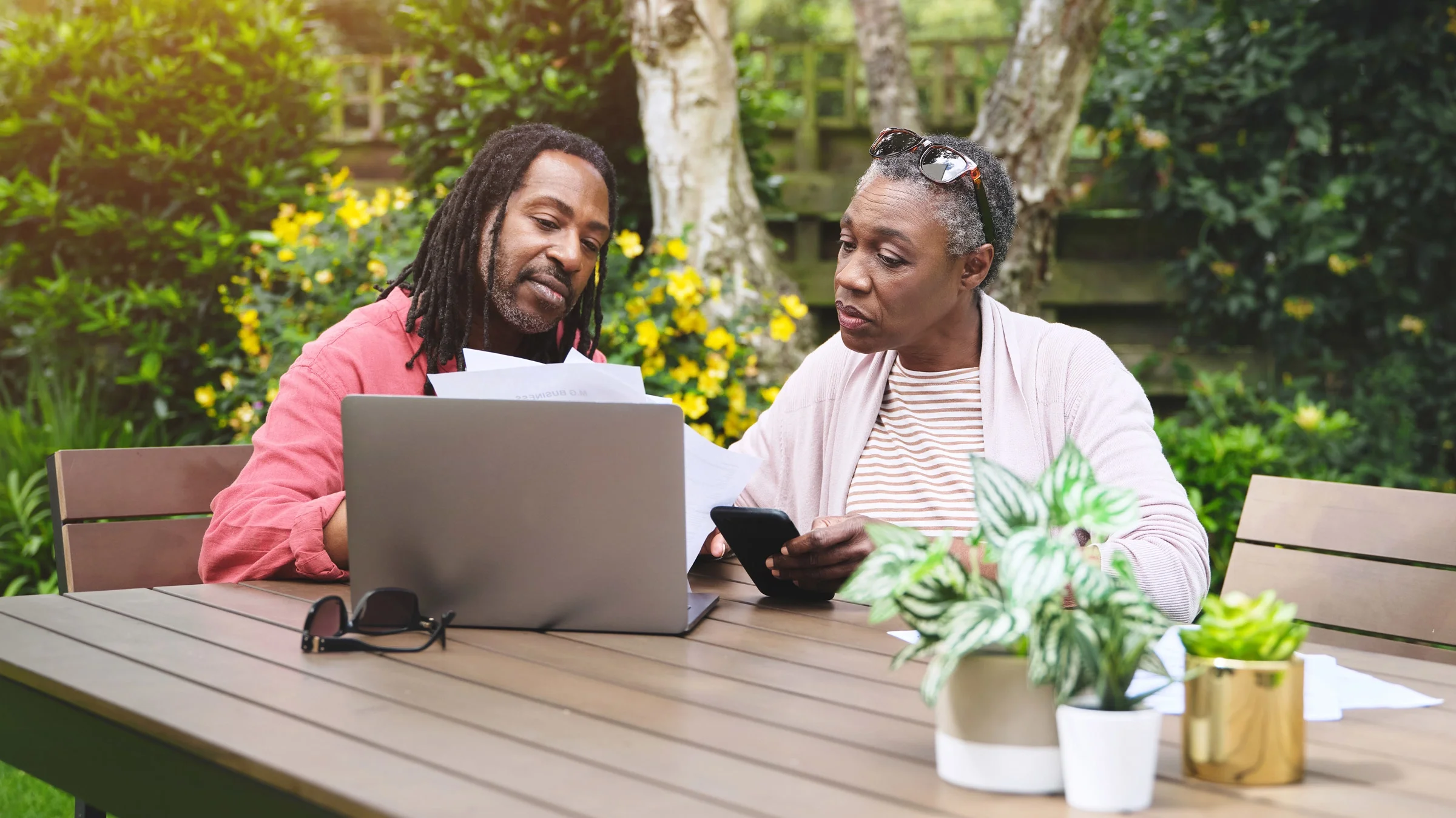 A senior couple doing finances on their laptop.