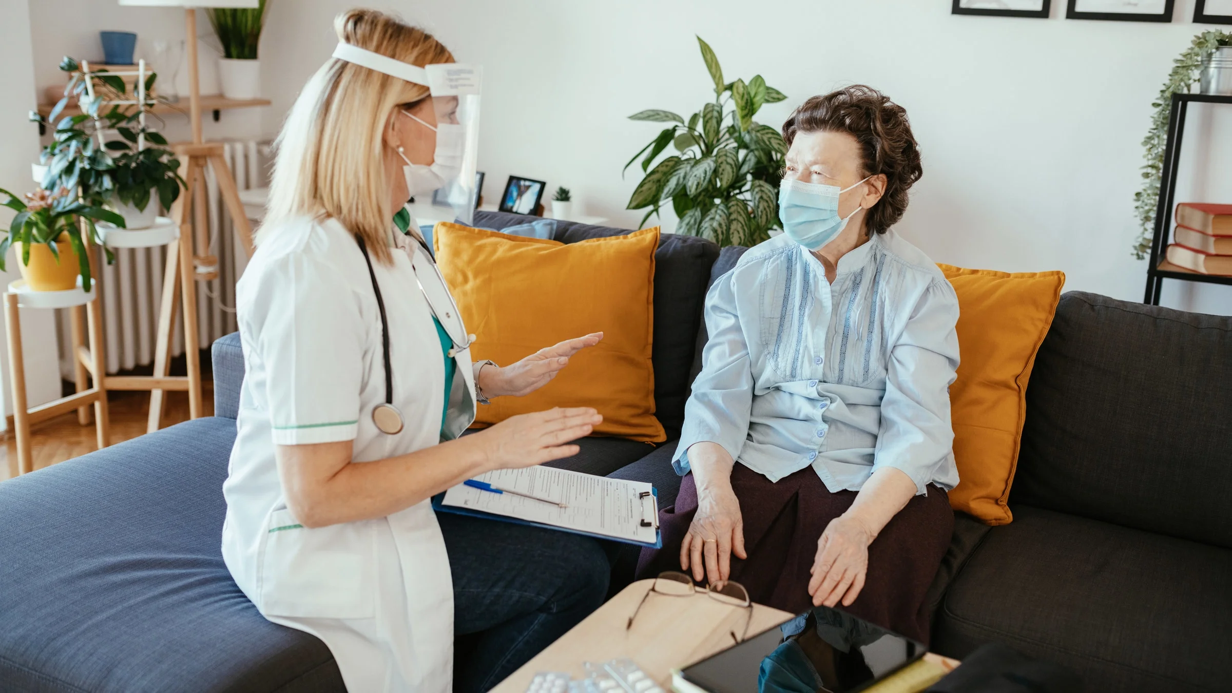 A nurse talking to a patient during a home visit.
