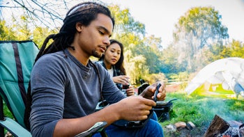 sulfonylureas: man checking glucose levels while camping with girlfriend 1044223528