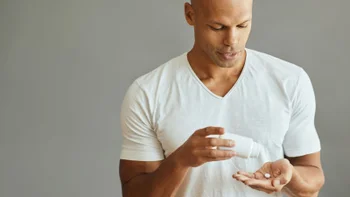 Azithromycin: man takes pill GettyImages 1401729007