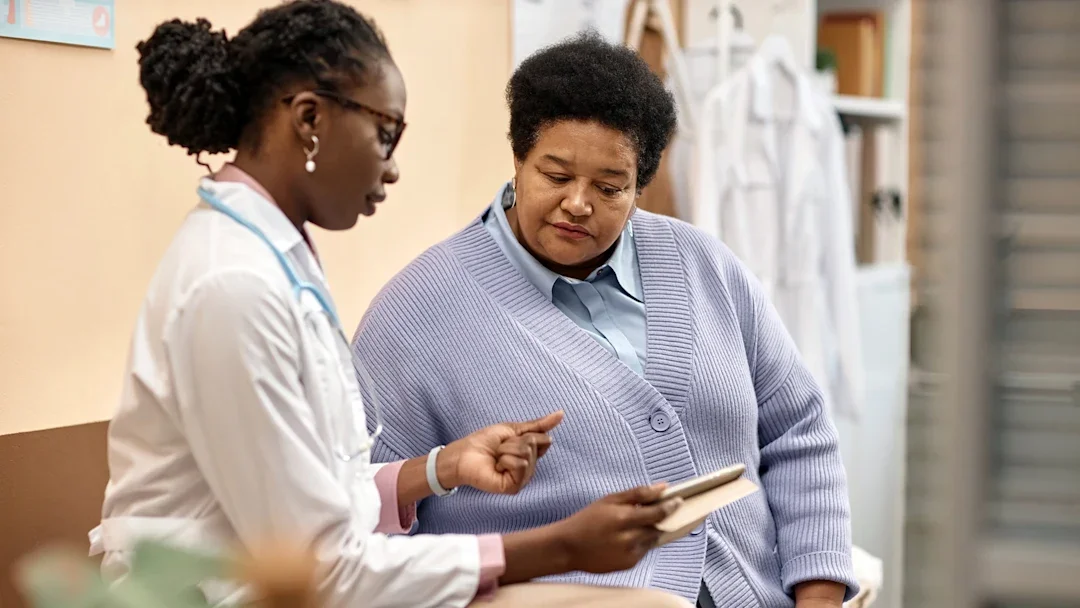 weight-loss: woman looking at digital tablet during medical appointment 1947527002