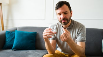 clonazepam: man taking medication at home 1475394041