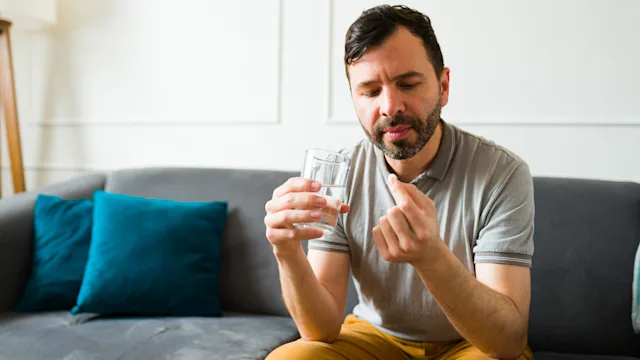clonazepam: man taking medication at home 1475394041