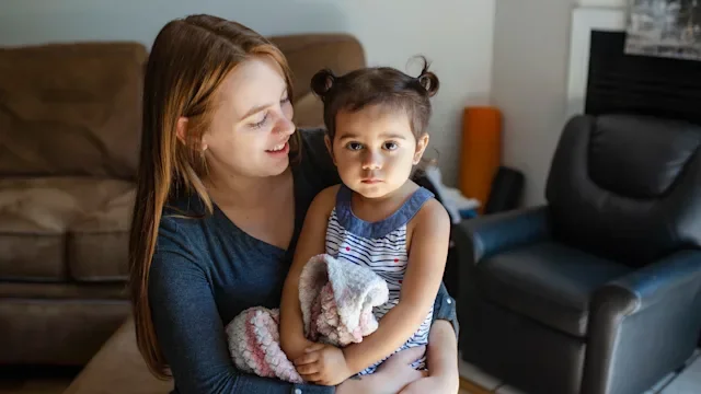 mother with toddler looking serious-1267558400